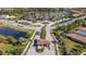 Aerial view of the gated community entrance, community pool, tennis courts, and lush landscaping at 5946 Caspian Tern Dr, Sarasota, FL 34238