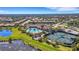 Aerial view of the community pool, tennis courts, landscaping, and surrounding homes at 5946 Caspian Tern Dr, Sarasota, FL 34238