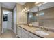 Bathroom featuring double sinks, granite countertops, large mirror and walk in shower at 5946 Caspian Tern Dr, Sarasota, FL 34238
