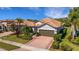 Beautiful single-story home with a tile roof, brick paver driveway, and a well-manicured front lawn at 5946 Caspian Tern Dr, Sarasota, FL 34238