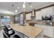 Stylish kitchen featuring a large island with seating, modern appliances, and white cabinetry at 5946 Caspian Tern Dr, Sarasota, FL 34238