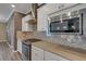 Modern kitchen with stainless steel appliances, granite countertops, custom tile backsplash, and ample counter space at 5946 Caspian Tern Dr, Sarasota, FL 34238