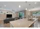 Spacious open layout with a kitchen island with granite counters, stainless steel appliances, and adjacent dining area at 5946 Caspian Tern Dr, Sarasota, FL 34238
