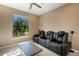 Living room featuring comfortable theater seating, a ceiling fan, and ample natural light at 5946 Caspian Tern Dr, Sarasota, FL 34238