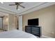 Spacious main bedroom featuring a ceiling fan and large dresser with a television at 5946 Caspian Tern Dr, Sarasota, FL 34238