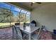 Screened-in patio offers outdoor dining space with views of the lush backyard at 5946 Caspian Tern Dr, Sarasota, FL 34238