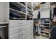 Custom walk-in closet features built-in shelving and drawers for optimal storage at 5946 Caspian Tern Dr, Sarasota, FL 34238