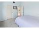 A cozy bedroom with light blue walls, soft patterned carpet, and a comfortable bed with striped bedding at 6071 Fairway Ln # 1424, Bradenton, FL 34210