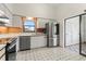 Bright kitchen features white cabinets, stainless steel appliances, and a window overlooking the yard at 6071 Fairway Ln # 1424, Bradenton, FL 34210