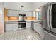 The kitchen features white cabinets, stainless steel appliances, and a unique tile floor pattern at 6071 Fairway Ln # 1424, Bradenton, FL 34210