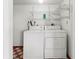 A simple laundry room with a side-by-side washer and dryer set and wire shelving at 6071 Fairway Ln # 1424, Bradenton, FL 34210