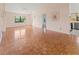 A spacious living room featuring parquet flooring, light paint, and view of the kitchen at 6071 Fairway Ln # 1424, Bradenton, FL 34210