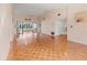 Spacious living room with sliding glass doors to the porch and wood floors at 6071 Fairway Ln # 1424, Bradenton, FL 34210