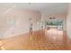 Open-concept living room with parquet flooring, a ceiling fan, and views of the outdoor balcony area at 6071 Fairway Ln # 1424, Bradenton, FL 34210