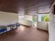 Covered porch area with outdoor seating, view of lush landscaping and a stairway at 6071 Fairway Ln # 1424, Bradenton, FL 34210