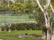 Putting green surrounded by lush landscaping and a tennis court in the background at 6071 Fairway Ln # 1424, Bradenton, FL 34210