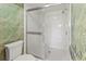 Shower stall with all-white tile, sliding glass door, and grab bar at 6071 Fairway Ln # 1424, Bradenton, FL 34210