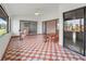 A bright sunroom with a table set, an accent chair, and patterned tile flooring at 6071 Fairway Ln # 1424, Bradenton, FL 34210