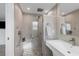 Finished bathroom featuring a frameless shower, handheld shower head, grab bars, and tiled walls at 6140 Midnight Pass Rd # B6, Sarasota, FL 34242