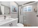 Bathroom featuring a modern vanity, tiled walk-in shower with glass door, and pebble tile floor at 6140 Midnight Pass Rd # B6, Sarasota, FL 34242
