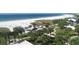 Breathtaking view of the beach from above, showing white sand, clear water, and lush greenery at 6140 Midnight Pass Rd # B6, Sarasota, FL 34242