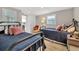 Bedroom features two twin beds with blue quilted blankets, hardwood floors and an armchair at 6140 Midnight Pass Rd # B6, Sarasota, FL 34242