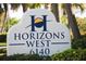 Sign for the Horizons West community with manicured landscaping at 6140 Midnight Pass Rd # B6, Sarasota, FL 34242