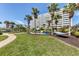 Relax by the building in a hammock amidst palm trees and lush green lawns at 6140 Midnight Pass Rd # B6, Sarasota, FL 34242