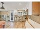 Under-construction kitchen with door to outside, white cabinets, stainless microwave, tile backsplash and wood-look flooring at 6140 Midnight Pass Rd # B6, Sarasota, FL 34242