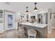 Bright kitchen featuring a center island with seating, stainless steel appliances, and white cabinetry at 6140 Midnight Pass Rd # B6, Sarasota, FL 34242