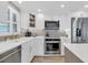 Updated kitchen featuring stainless steel appliances, modern cabinets and countertops, and a stylish backsplash at 6140 Midnight Pass Rd # B6, Sarasota, FL 34242