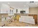 Unfinished kitchen features white cabinets, stainless microwave, tile backsplash and light wood-look flooring at 6140 Midnight Pass Rd # B6, Sarasota, FL 34242