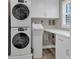 Well-equipped laundry room with modern washer, dryer, and ample counter space at 6140 Midnight Pass Rd # B6, Sarasota, FL 34242