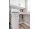 Laundry room featuring a water softener and ample shelving at 6140 Midnight Pass Rd # B6, Sarasota, FL 34242