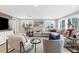 Bright living room with modern decor, large windows, and a comfortable sectional sofa at 6140 Midnight Pass Rd # B6, Sarasota, FL 34242