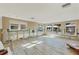 Spacious room under renovation with new flooring, windows, and exposed wall framing at 6140 Midnight Pass Rd # B6, Sarasota, FL 34242