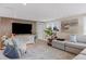 Cozy living room with a large TV, comfortable seating, and stylish decor at 6140 Midnight Pass Rd # B6, Sarasota, FL 34242