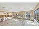 Spacious room under renovation with new flooring, windows, and exposed wall framing at 6140 Midnight Pass Rd # B6, Sarasota, FL 34242