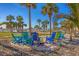 Relax in colorful rocking chairs near the beach, surrounded by palm trees on a sunny day at 6140 Midnight Pass Rd # B6, Sarasota, FL 34242