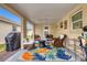 Covered patio featuring comfortable seating and a colorful rug, perfect for outdoor relaxation at 6140 Midnight Pass Rd # B6, Sarasota, FL 34242