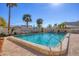 Community swimming pool surrounded by lush palm trees and comfortable lounge chairs at 6140 Midnight Pass Rd # B6, Sarasota, FL 34242
