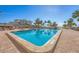 Community swimming pool set against a backdrop of palm trees and clear blue sky at 6140 Midnight Pass Rd # B6, Sarasota, FL 34242