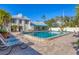 Community pool featuring a seating area and a well-maintained surrounding landscape at 6140 Midnight Pass Rd # B6, Sarasota, FL 34242