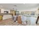 Unfinished room with wood look flooring, new window installation, and white kitchen cabinets at 6140 Midnight Pass Rd # B6, Sarasota, FL 34242