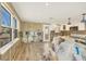 View of a room under construction with new windows and wood-look flooring at 6140 Midnight Pass Rd # B6, Sarasota, FL 34242