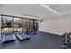 Well-equipped gym featuring treadmills, elliptical machines, free weights, and a wall-mounted TV at 6285 Midnight Pass Rd # 101, Sarasota, FL 34242