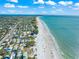 Expansive aerial view showcasing the coastline, white sand beach, and beachfront houses at 6537 Gulf Of Mexico Dr, Longboat Key, FL 34228