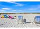 Sunny beach scene featuring lounge chairs and beach umbrella on pristine white sand at 6537 Gulf Of Mexico Dr, Longboat Key, FL 34228