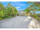 Spacious home with a three car garage and ample parking space surrounded by lush greenery at 6537 Gulf Of Mexico Dr, Longboat Key, FL 34228