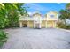 Stunning three-story beach house with a charming white balcony and multiple garages at 6537 Gulf Of Mexico Dr, Longboat Key, FL 34228